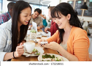 Two Female Friends Friends Meeting For Lunch In Coffee Shop