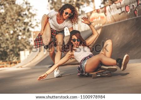 Similar – Young man riding on skate and holding surfboard