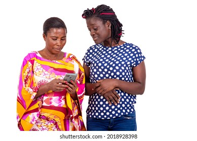 Two Female Friends Using Mobile Apps For Online Shopping Standing Against White Background