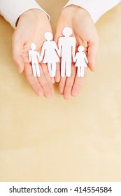 Two Female Hands Holding A Paper Family Sillhouette