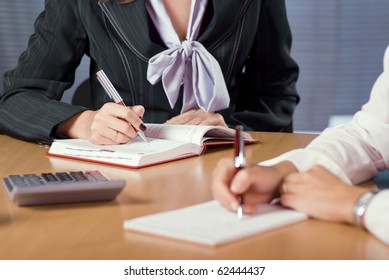 Two Female Hands That Taking Notes At The Meeting