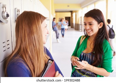 Two Female High School Students Talking By Lockers