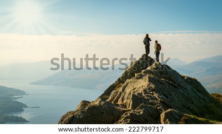 Two female hikers on top of the mountain enjoying valley view, Ben A'an, Loch Katrine, Highlands, Scotland, UK