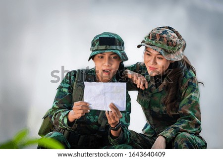 Two female military smile and happiness after reading mail that sent from their family.
