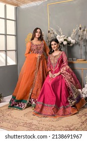 Two female models wearing traditional pakistaniindian shalwar kameez ethnic wear. Intricate embroidered chiffon and oraganza attire for events and party  wear.
Karachi, Sindh, Pakistan 24 March 2022