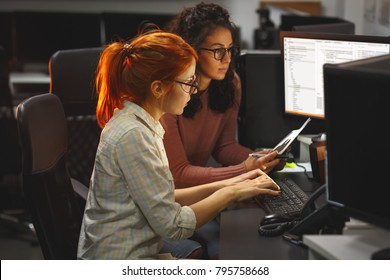 Two Female Programmers Working On New Project.They Working Late At Night At The Office.