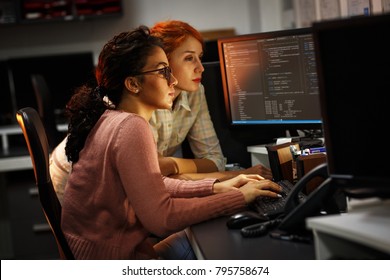 Two female programmers working on new project.They working late at night at the office. - Shutterstock ID 795758674
