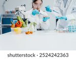 Two female researchers in the lab work at a desk on plant genetic modification for food, meat, and vegetables, utilizing advanced genetic engineering technology to enhance crops and animal feed.