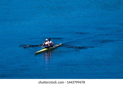 Two Female Rowers In A Double Racing Boat With Synchronous Oar Stroke