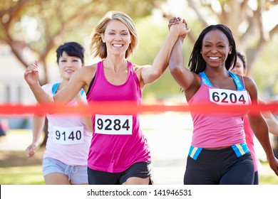 Two Female Runners Finishing Race Together