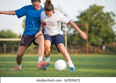 two female soccer players on the field