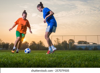 Two female soccer players on the field - Powered by Shutterstock