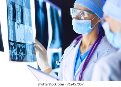 Two female women medical doctors looking at x-rays in a hospital
