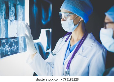 Two female women medical doctors looking at x-rays in a hospital. - Shutterstock ID 793192228