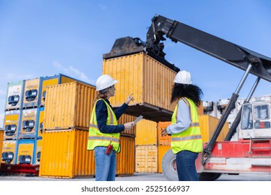  Two Female Workers Overseeing Heavy Machinery Lifting Shipping Containers at a Cargo Yard, Ensuring Safe Operations - Powered by Shutterstock