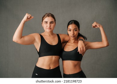 Two females flexing there arm muscles and showing of there toned bodies - Shutterstock ID 2181198723