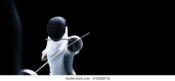 Two fencers are fighting in a tournament. The concept of fencing. Mixed media - Powered by Shutterstock