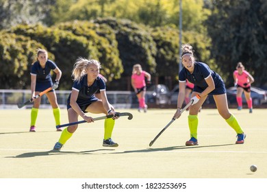 Two field hockey female players getting the ball for penalty shot - Powered by Shutterstock