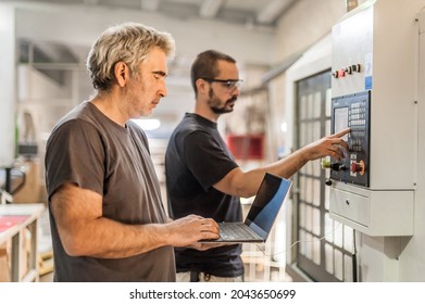 Two Field Service Maintenance Engineer Technician Electrician Inspect And Control Machine Hardware And Software System With Laptop Computer. Electric Installation