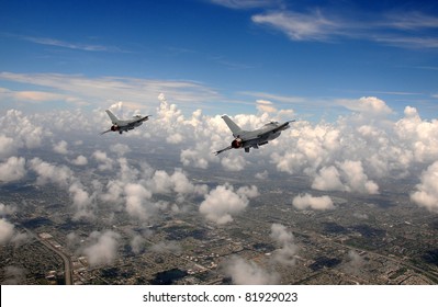 Two Fighter Jets Flying At High Altitude