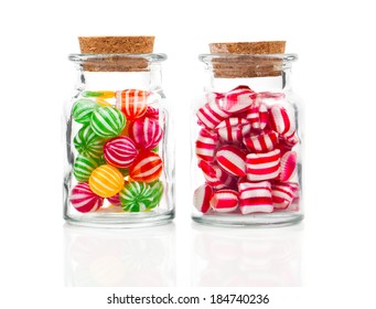 two filled glass candy jars isolated over white background
