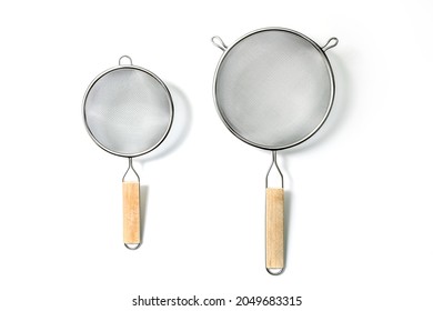 Two Fine Mesh Strainers - large and small. Silver colored metalic colanders with wooden handle isolated on a white background
				