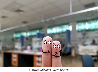 Two Fingers Are Decorated As Two Person In Intensive Care Unit. They Are Glad That The Best Treatment Is Given To Their Sick Family Member.