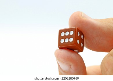 Two Fingers Holding A Gaming Dice