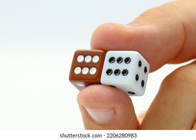 Two Fingers Holding Two Gaming Dices