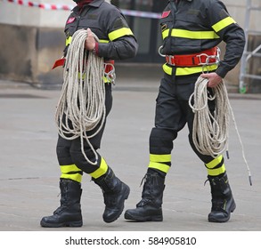 Two Firefighters With A Long Rope During The Rescue Operation