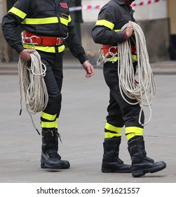 Two Firefighters With A Long Rope During The Rescue Operation