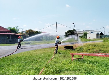 Two Firemen During Fire Drill Exercise