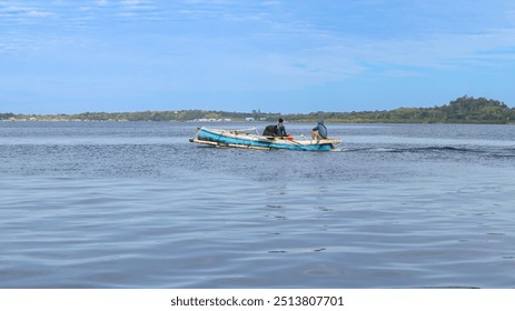 Two fishermen in a small wooden boat on a calm sea, with a distant shoreline and blue sky. - Powered by Shutterstock