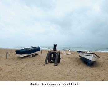 Two fishing boats and a winch at the beach of Los Boliches, Fuengirola, Málaga, Spain on a on a autumn cloudy day. October 2024. - Powered by Shutterstock