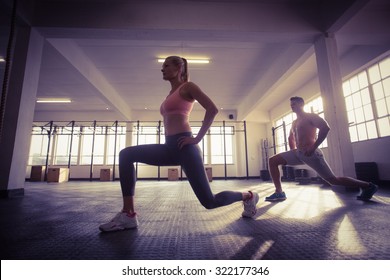 Two fit people doing fitness in crossfit gym - Powered by Shutterstock