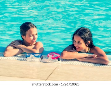 Two Fit Sporty Women Talking At The Border Of Swimming Pool