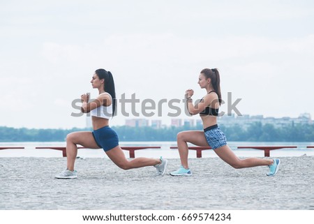 Similar – Image, Stock Photo Two fit women doing sports together, using a medicine ball to tone their body. Urban scene.