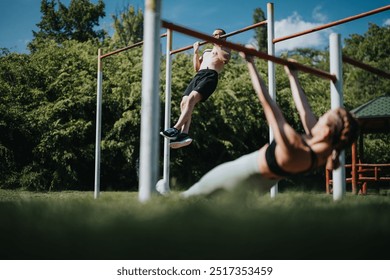 Two fitness enthusiasts are performing calisthenics exercises on parallel bars in a scenic outdoor setting, showcasing strength and determination. - Powered by Shutterstock