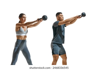 Two fitness enthusiasts wearing fashion clothes in middle of kettlebell workout against white studio background. Concept of people in sport, healthy lifestyle, teamwork, motivation. Ad - Powered by Shutterstock