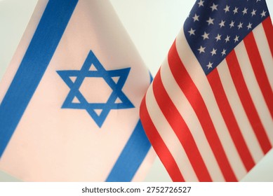 Two flags flutter together, symbolizing a strong bond between Israel and the United States. The blue and white of Israel's flag complements the red, white, and blue of the U.S.