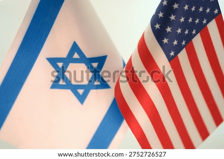 Two flags flutter together, symbolizing a strong bond between Israel and the United States. The blue and white of Israel's flag complements the red, white, and blue of the U.S.