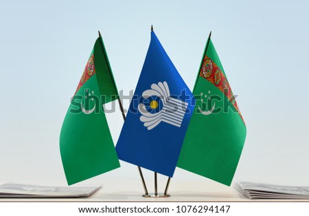 Two flags of Turkmenistan and CIS flag between
