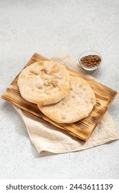 two flat breads on a board