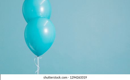 Two Floating Pastel Blue Balloons