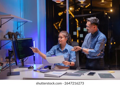 Two focused coders facing each other writing code in software development office while team of coders are developing artificial intelligence. Team of programmers innovating algorithm cod