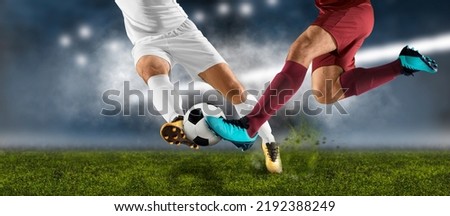 Two football player man in action on dark arena background