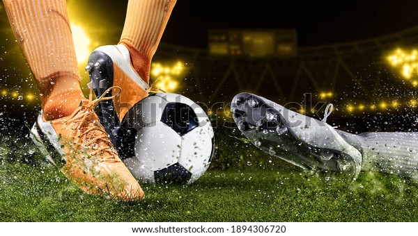 Two football player man in\
action on dark arena background. Soccer player making sliding\
tackle