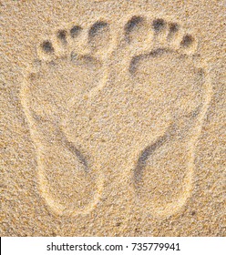 Two Footprints In Sand At The Beach