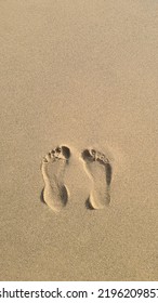 Two Footprints In The Sand On The Beach