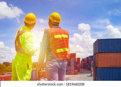 Two foreman are discussing for stacking box container for logistics service transportation 